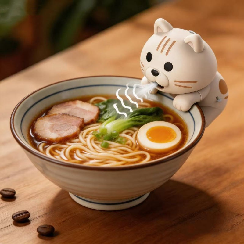 Blowing Kitten – white kitten cooling fan on a ramen bowl